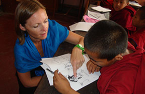 volunteer teaching young monks